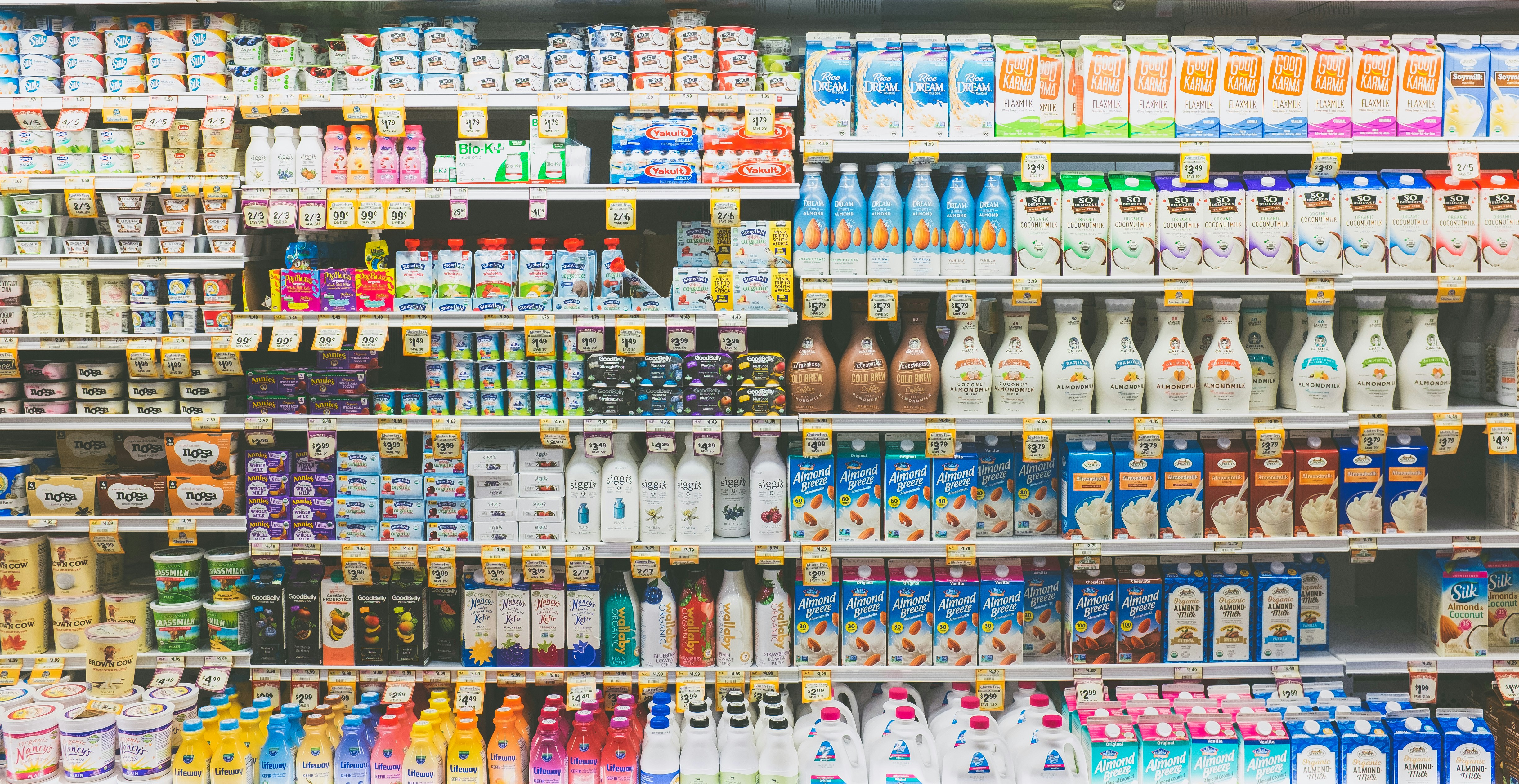 Assorted drinks on display in a retail refrigerator